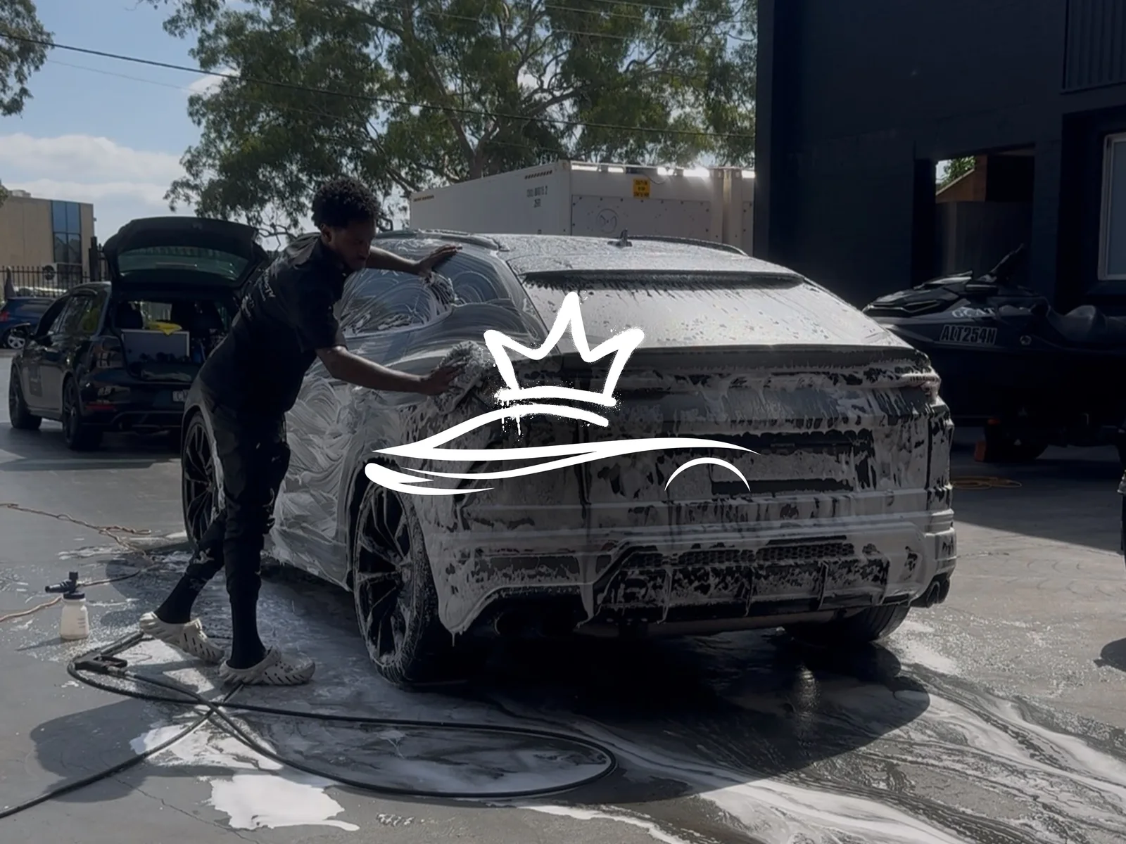 Detail Dynasty carefully washing a vehicle by hand